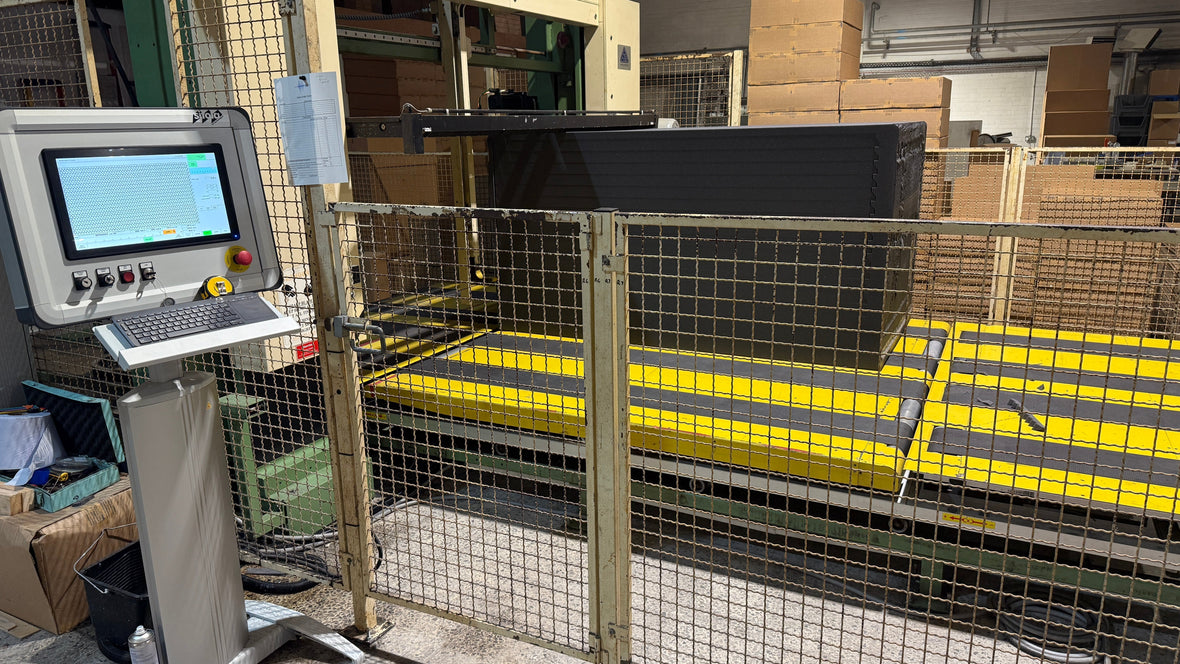 CNC machine cutting custom wedge profiled acoustic foam sheets for a customer